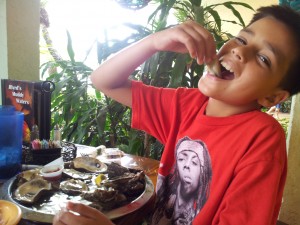 muddy waters-pic -8 yr old-Mateo- eating oysters 1