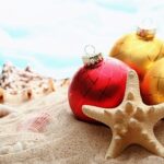 Christmas balls and seashells on the beach