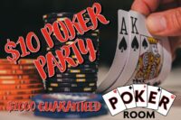 A person holding up two cards in front of a stack of poker chips.