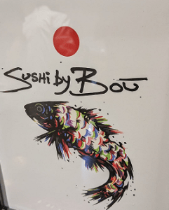 A fish is painted on the side of a refrigerator.